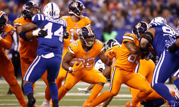 INDIANAPOLIS, IN - DECEMBER 14:  C.J. Anderson #22 of the Denver Broncos runs with the ball against...