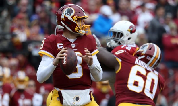 LANDOVER, MD - DECEMBER 17: Quarterback Kirk Cousins #8 of the Washington Redskins looks to pass in...