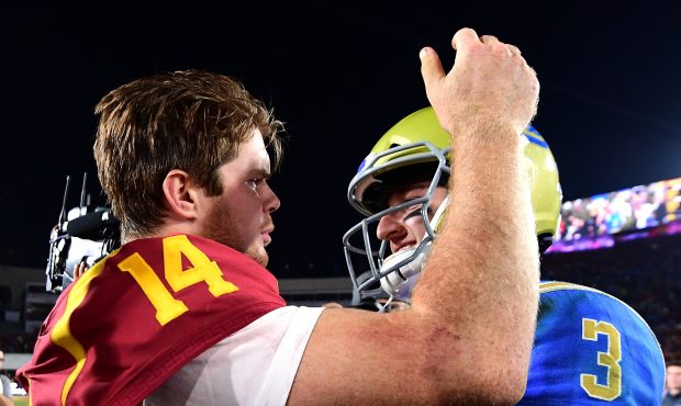 Josh Rosen #3 of the UCLA Bruins and Sam Darnold #14 of the USC Trojans meet on the field after a 2...