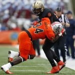 Jordan Akins #88 of the South team is tackled by Dewey Jarvis #94 of the North team during the first half of the Reese's Senior Bowl at Ladd-Peebles Stadium on January 27, 2018 in Mobile, Alabama.  (Photo by Jonathan Bachman/Getty Images)