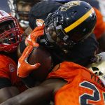 Ito Smith #25 of the South team is tackled by Greg Gilmore #94 of the South team and Isaac Yiadom #20 during the second half of the Reese's Senior Bowl at Ladd-Peebles Stadium on January 27, 2018 in Mobile, Alabama.  (Photo by Jonathan Bachman/Getty Images)