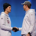 Tom Brady #12 of the New England Patriots and Nick Foles #9 of the Philadelphia Eagles shake hands during Super Bowl Media Day at Xcel Energy Center on January 29, 2018 in St Paul, Minnesota.  Super Bowl LII will be played between the New England Patriots and the Philadelphia Eagles on February 4.  (Photo by Elsa/Getty Images)