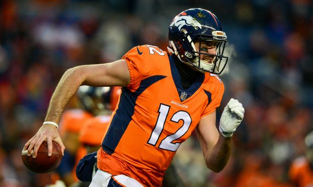 DENVER, CO - DECEMBER 31:  Quarterback Paxton Lynch #12 of the Denver Broncos scrambles against the...