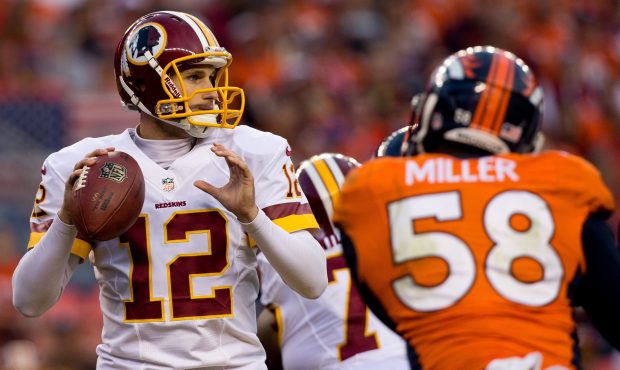 Quarterback Kirk Cousins #12 of the Washington Redskins looks to pass at Sports Authority Field Fie...