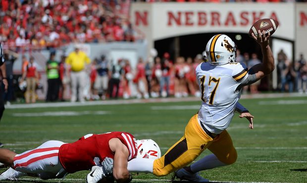 LINCOLN, NE - SEPTEMBER 10: Quarterback Josh Allen #17 of the Wyoming Cowboys passes out of the hol...