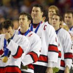 Theo Fleury #74, Joe Sakic #91 and Mario Lemieux of Canada look on as the Canadian National Anthem during the men's ice hockey gold medal game of the Salt Lake City Winter Olympic Games at the E Center in Salt Lake City, Utah. Canada defeated the USA 5-2.  DIGITAL IMAGE. Mandatory Credit:  Al Bello/Getty Images