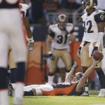 Wide receiver Ed McCaffrey #87 of the Denver Broncos celebrates lying down after scoring the winning touchdown on a 23-yard pass against the St. Louis Rams in the second half of the game on September 8, 2002 at Mile High Stadium in Denver, Colorado.  The Broncos won 23-16.  (Photo by Brian Bahr/Getty Images)