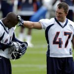 Denver Broncos John Lynch,  right, wipes off grass from fellow Bronco, Champ Bailey's  head during the morning session of the first day of training camp at Dove Valley Wednesday morning. THE DENVER POST/ ANDY CROSS  (Photo By Andy Cross/The Denver Post via Getty Images)