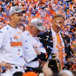 DENVER, CO - JANUARY 19:   Peyton Manning #18, head coach John Fox and John Elway, executive vice president of football operations for the Denver Broncos, celebrate after they defeated the New England Patriots 26 to 16 in the AFC Championship game at Sports Authority Field at Mile High on January 19, 2014 in Denver, Colorado.  (Photo by Jamie Squire/Getty Images)
