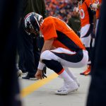 DENVER, CO - NOVEMBER 15:  Quarterback Peyton Manning #18 of the Denver Broncos crouches on the sidelines during a game against the Kansas City Chiefs at Sports Authority Field Field at Mile High on November 15, 2015 in Denver, Colorado. (Photo by Justin Edmonds/Getty Images)