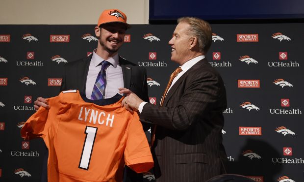 Denver Broncos executive vice president John Elway gives first round pick QB Paxton Lynch a jersey ...