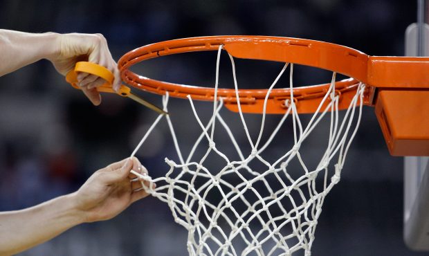 A detail of a player from the North Carolina Tar Heels cutting down a piece of the net after North ...