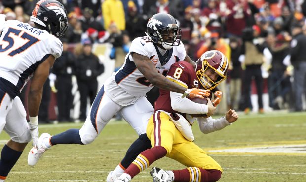 Denver Broncos cornerback Aqib Talib (21) stops a scrambling Washington Redskins quarterback Kirk C...
