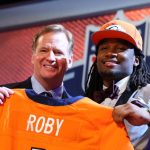 Bradley Roby of the Ohio State Buckeyes poses with NFL Commissioner Roger Goodell after he was picked #31 overall by the Denver Broncos during the first round of the 2014 NFL Draft at Radio City Music Hall on May 8, 2014 in New York City.  (Photo by Elsa/Getty Images)