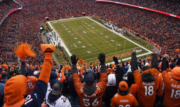Broncos fans cheer after Darian Stewart intercepted Tom Brady during the AFC championship game agai...