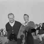 Fellow golf champion Arnold Palmer (R) presents Jack Nicklaus with his green jacket after winning the 1963 Masters Tournament.