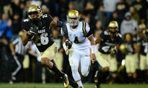 Defensive back Isaiah Oliver #26 of the Colorado Buffaloes returns a punt for yardage against the U...