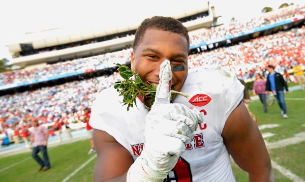 Bradley Chubb #9 of the North Carolina State Wolfpack leaves the field with a piece of the Kenan St...