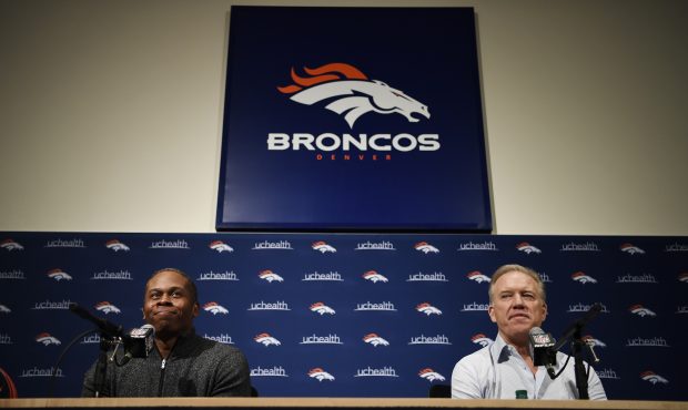 Denver Broncos head coach Vance Joseph and executive vice president of football operations John Elw...