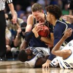 Eric Paschall #4 of the Villanova Wildcats competes for the ball with Moritz Wagner #13 and Isaiah Livers #4 of the Michigan Wolverines in the first half during the 2018 NCAA Men's Final Four National Championship game at the Alamodome on April 2, 2018 in San Antonio, Texas.  (Photo by Ronald Martinez/Getty Images)
