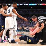 Phil Booth #5 of the Villanova Wildcats and Moritz Wagner #13 of the Michigan Wolverines exchange words after competing for a loose ball in the first half during the 2018 NCAA Men's Final Four National Championship game at the Alamodome on April 2, 2018 in San Antonio, Texas.  (Photo by Tom Pennington/Getty Images)