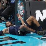 Zavier Simpson #3 of the Michigan Wolverines falls to the floor after getting fouled by the Villanova Wildcats in the second half during the 2018 NCAA Men's Final Four National Championship game at the Alamodome on April 2, 2018 in San Antonio, Texas.  (Photo by Chris Covatta/Getty Images)