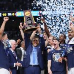 SAN ANTONIO, TX - APRIL 02:  Head coach Jay Wright of the Villanova Wildcats raises the trophy with his team after defeating the Michigan Wolverines during the 2018 NCAA Men's Final Four National Championship game at the Alamodome on April 2, 2018 in San Antonio, Texas.  Villanova defeated Michigan 79-62.  (Photo by Tom Pennington/Getty Images)