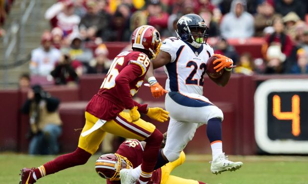 LANDOVER, MD - DECEMBER 24: Running back C.J. Anderson #22 of the Denver Broncos runs with the ball...
