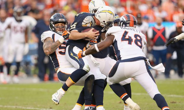 Quarterback Philip Rivers #17 of the San Diego Chargers is sacked by linebackers Shane Ray #56 and ...