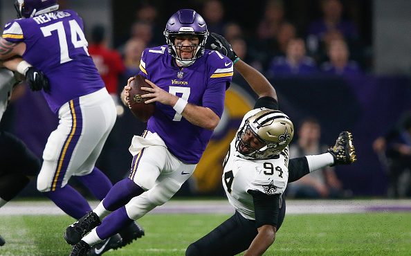 Case Keenum #7 of the Minnesota Vikings scrambles with the ball chased by Cameron Jordan #94 of the...