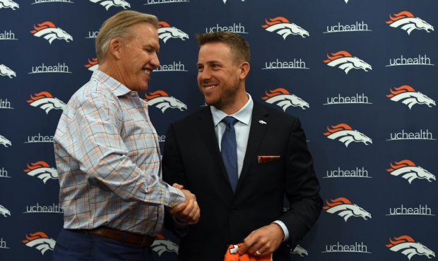 Denver Broncos quarterback Case Keenum shakes hands with John Elway, general manager and executive ...