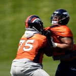 Denver Broncos offensive tackle Menelik Watson (75) drives offensive tackle Elijah Wilkinson (68) on the first day of Broncos OTA's at the UCHealth Training Center in Englewood. May 22, 2018 Englewood, Colorado. (Photo by Joe Amon/The Denver Post via Getty Images)