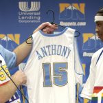 Denver Nuggets general manager Kiki Vandeweghe, left, hands a Nuggets uniform to Carmelo Anthony from Syracuse University, whom the Denver Nuggets selected third overall in 2003 NBA Draft. (Photo By Hyoung Chang/The Denver Post via Getty Images)
