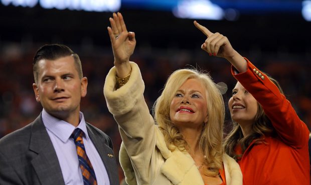 Annabel Bowlen (center), wife of Denver Broncos owner Pat Bowlen, waves alongside their son John (l...