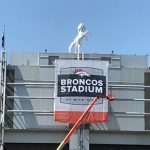 Crews put up new signage at Broncos Stadium at Mile High on July 9, 2018, in Denver. (Photo by Armen Williams/Sports Radio 104.3 The Fan)