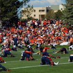 ENGLEWOOD, CO - JULY 26:  A capacity crowd of fans watch as the Denver Broncos warm up during training camp at the Paul D. Bowlen Memorial Broncos Centre at Dove Valley on July 26, 2012 in Englewood, Colorado.  (Photo by Doug Pensinger/Getty Images)