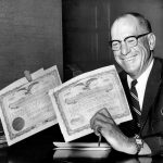 MAY 17 1965, MAY 18 1965, DEC 26 1965; Phipps Family Now Has 99 Per Cent Of These Certificates; A smiling Gerald Phipps shows a portion of the majority stock he now holds in Empire Sports Inc., owners of the Denver Broncos and Denver Bears professional sports teams. Phipps announced Monday that his family now controls more than 99 per cent of stock.;  (Photo By Jack  Riddle/The Denver Post via Getty Images)