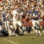 Los Angeles Rams quarterback Roman Gabriel rolls out to his left to avoid Denver Broncos defensive tackle Paul Smith in a 16-10 loss at the Los Angeles Coliseum on 11/12/1972. (Photo by Vic Stein/Getty Images)