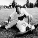JUL 21 1987 Football - Denver Broncos - Training Camp Bronco trainer Steve Antonapolous (sp?) helps veteran Orson Mobley stretch out after his set of 40-yard dashes during opening day of Training camp in Greeley. Credit: The Denver Post (Denver Post via Getty Images)
