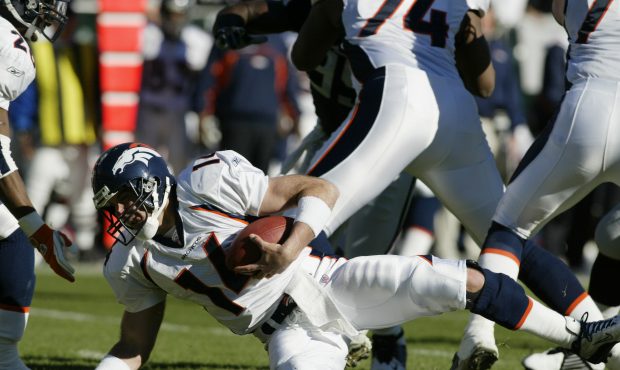 OAKLAND, CA - DECEMBER 22:  Quarterback Brian Griese #14 of the Denver Broncos goes down with the b...