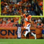DENVER, CO - AUGUST 18:  Quarterback Paxton Lynch #12 of the Denver Broncos leaps and passes on the run in the fourth quarter during an NFL preseason game against the Chicago Bears at Broncos Stadium at Mile High on August 18, 2018 in Denver, Colorado. (Photo by Dustin Bradford/Getty Images)