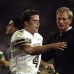 5 Sep 1998:  Quarterback Mike Moschetti #4 of the Colorado Buffaloes talks to head coach Rick Neuheisel during a game against the Colorado St. Rams at the Mile High Stadium in Denver, Colorado. The Buffaloes defeated the Rams 42-14. Mandatory Credit: Bria