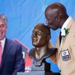 Former Denver Broncos running back Terrell Davis kisses his bust as presenter Neil Schwartz looks on during the Pro Football Hall of Fame Enshrinement Ceremony at Tom Benson Hall of Fame Stadium on Aug. 5, 2017 in Canton, Ohio. (Photo by Joe Robbins/Getty Images)