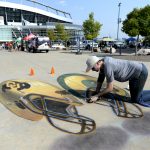 DENVER, CO - SEPTEMBER  1: Chris Carlson works on some sidewalk chalk art prior to the Colorado Buffaloes Colorado State Rams game on September 1, 2017 in Denver, Colorado at Sports Authority Field.  (Photo by John Leyba/The Denver Post via Getty Images)