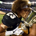 DENVER, CO - SEPTEMBER  1: Colorado Buffaloes running back Phillip Lindsay (23) kisses the Rocky Mountain Showdown trophy as its held by wide receiver Shay Fields (1) after their win over the Colorado State Rams 17-3 on September 1, 2017 in Denver, Colorado at Sports Authority Field.  (Photo by John Leyba/The Denver Post via Getty Images)
