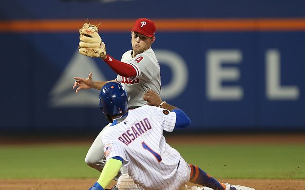 Amed Rosario #1 of the New York Mets is caught stealing second base by shortstop Scott Kingery #4 o...