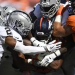 DENVER, CO - SEPTEMBER 16: Royce Freeman (28) of the Denver Broncos is tackled by Oakland Raiders defenders during the first quarter. The Denver Broncos hosted the Oakland Raiders at Broncos Stadium at Mile High in Denver, Colorado on Sunday, September 16, 2018. (Photo by Andy Cross/The Denver Post via Getty Images)