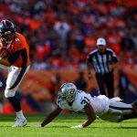 DENVER, CO - SEPTEMBER 16:  Quarterback Case Keenum #4 of the Denver Broncos scrambles as defensive back Marcus Gilchrist #31 of the Oakland Raiders defends in the fourth quarter of a game at Broncos Stadium at Mile High on September 16, 2018 in Denver, Colorado. (Photo by Dustin Bradford/Getty Images)