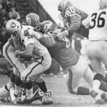 NOV 20 1966, NOV 23 1966, NOV 27 1966 Denver Broncos - Action Oakland quarterback Tom Flores learns Bronco blitz can be mighty effective as Max Leetzow (81), Dan LaRose (80) and Goose Gonsoulin throw the Raider for a loss of eight yards in the first quarter. Oakland's Clem Daniels tries to block. Credit: Denver Post (Denver Post via Getty Images)