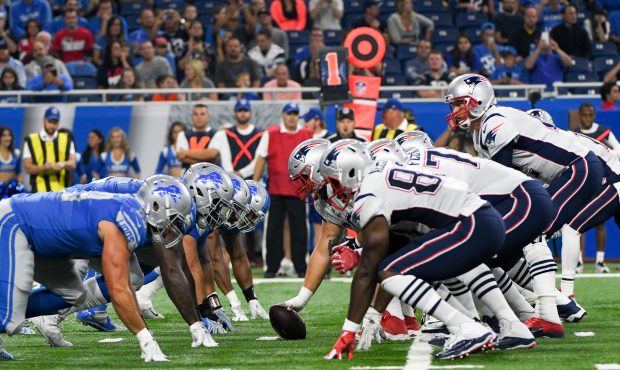 New England Patriots quarterback Tom Brady (12) calls signals from under center in the first quarte...